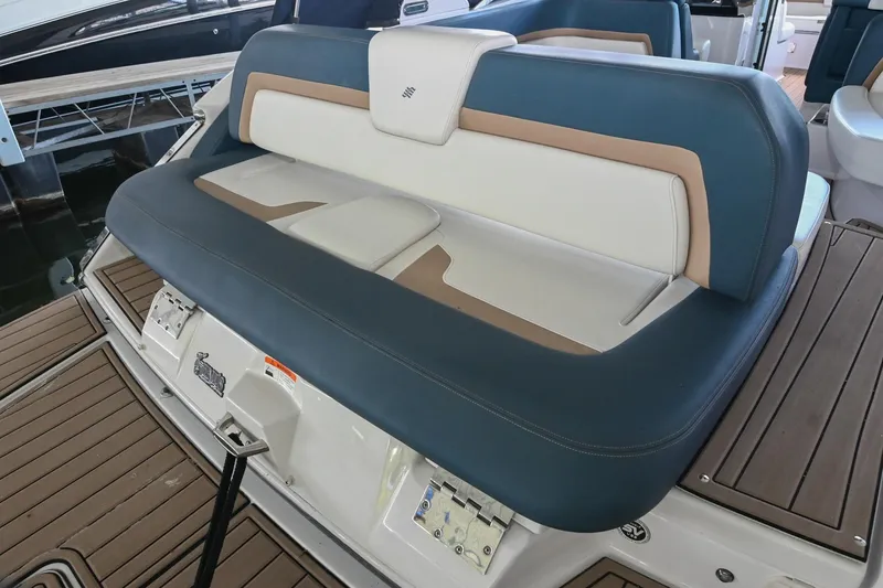 Slide: The Image of 2014 Four Winns H290 boat seating with blue and white upholstery on deck. - 5