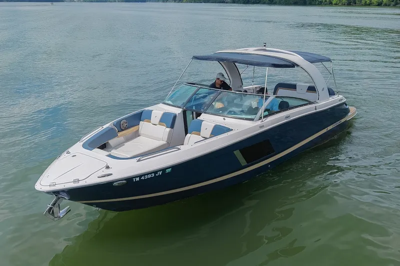 Slide: The Image of 2014 Four Winns H290 boat cruising on a calm lake. - 5
