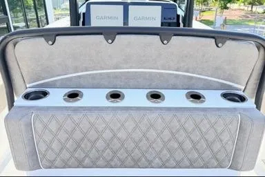 Slide: The Image of 2026 Sea Hunt Gamefish 27 boat seating with cup holders and Garmin electronics. - 13
