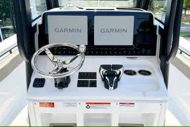 Slide: The Image of 2026 Sea Hunt Gamefish 27 helm with dual Garmin displays and modern controls. - 14