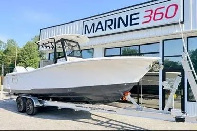 Slide: The Image of 2026 Sea Hunt Gamefish 27 boat on trailer outside Marine 360 dealership. - 2