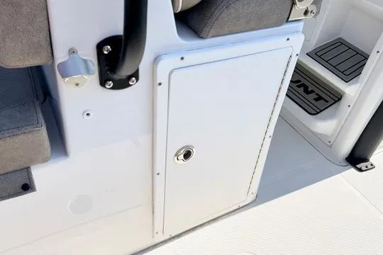 Slide: The Image of 2026 Sea Hunt Gamefish 27 Forward Seating boat interior, featuring storage compartment and seating area. - 22
