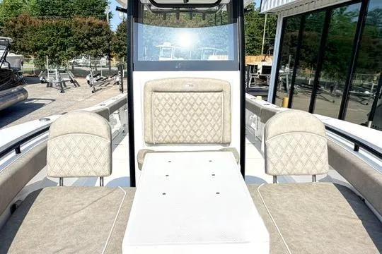 Slide: The Image of 2026 Sea Hunt Gamefish 27 Forward Seating boat with beige cushioned seats and sleek design. - 28