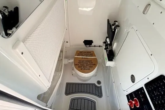 Slide: The Image of Interior of 2026 Sea Hunt Gamefish 27, featuring a compact marine toilet area. - 34