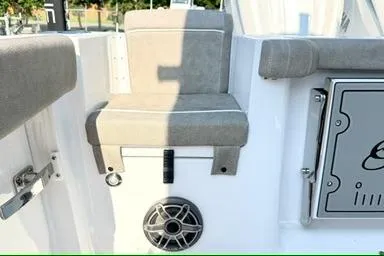 Slide: The Image of 2026 Sea Hunt Gamefish 27 boat seating area with speaker and storage compartment. - 8
