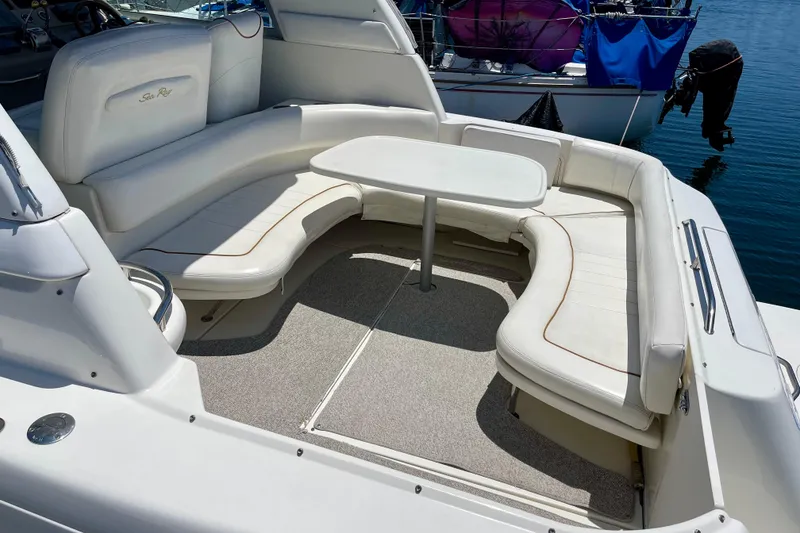Slide: The Image of 2000 Sea Ray Sundancer 310 boat with white seating and table on deck. - 10