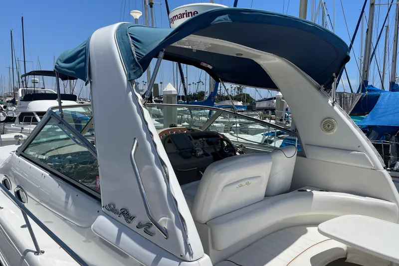 Slide: The Image of 2000 Sea Ray Sundancer 310 yacht with blue canopy, docked in marina. - 11