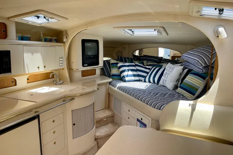 Slide: The Image of Interior of 2000 Sea Ray Sundancer 310 yacht with cozy seating and kitchenette. - 16