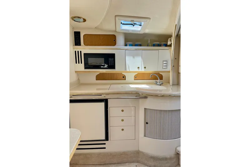 Slide: The Image of Interior of 2000 Sea Ray Sundancer 310 yacht kitchen with microwave and sink. - 17