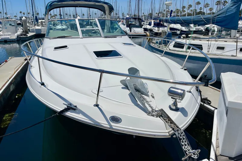 Slide: The Image of 2000 Sea Ray Sundancer 310 docked in a marina, surrounded by other boats. - 2