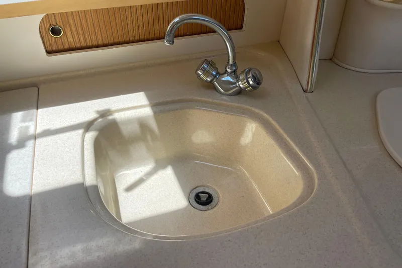 Slide: The Image of Kitchen sink and faucet on a 2000 Sea Ray Sundancer 310 boat. - 21