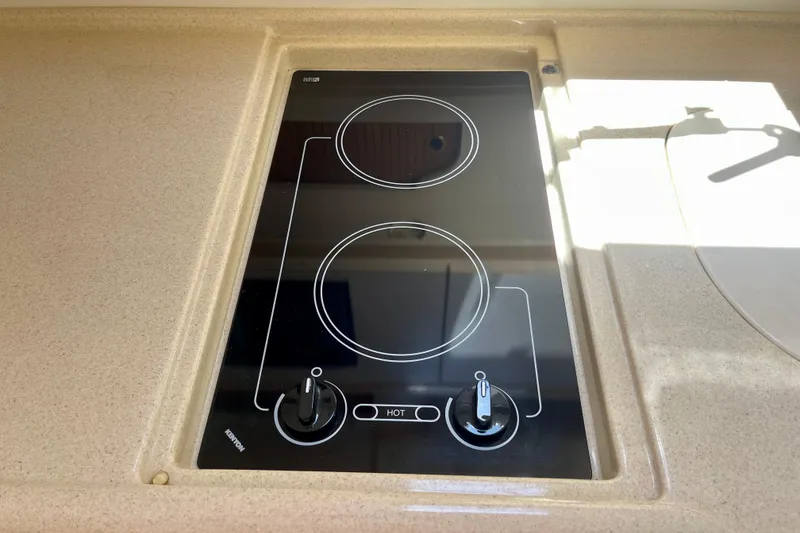 Slide: The Image of Built-in stovetop on 2000 Sea Ray Sundancer 310 yacht, featuring two burners and control knobs. - 23