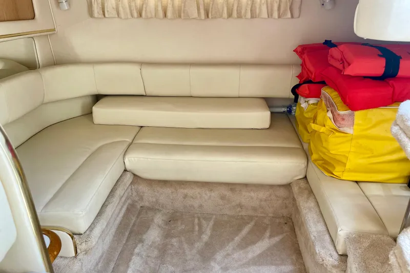 Slide: The Image of Interior of 2000 Sea Ray Sundancer 310 with beige seating and life jackets. - 26