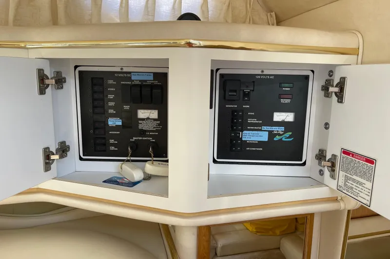 Slide: The Image of Electrical panel inside a 2000 Sea Ray Sundancer 310 boat, featuring 12V and 120V controls. - 27