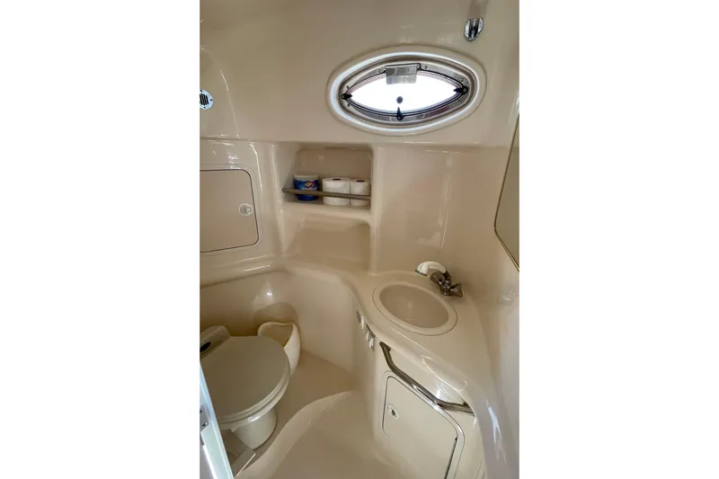 Slide: The Image of Compact bathroom in 2000 Sea Ray Sundancer 310 yacht, featuring toilet, sink, and storage. - 28