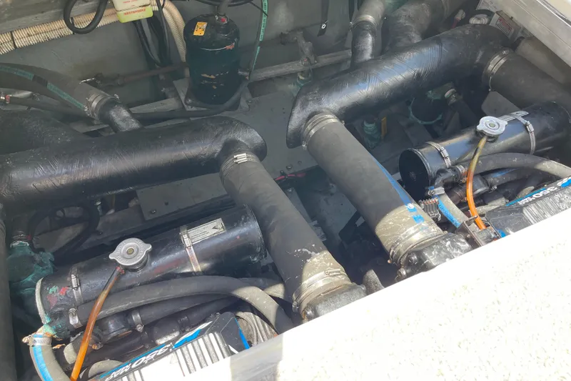 Slide: The Image of Engine compartment of a 2000 Sea Ray Sundancer 310 boat, showing hoses and components. - 30