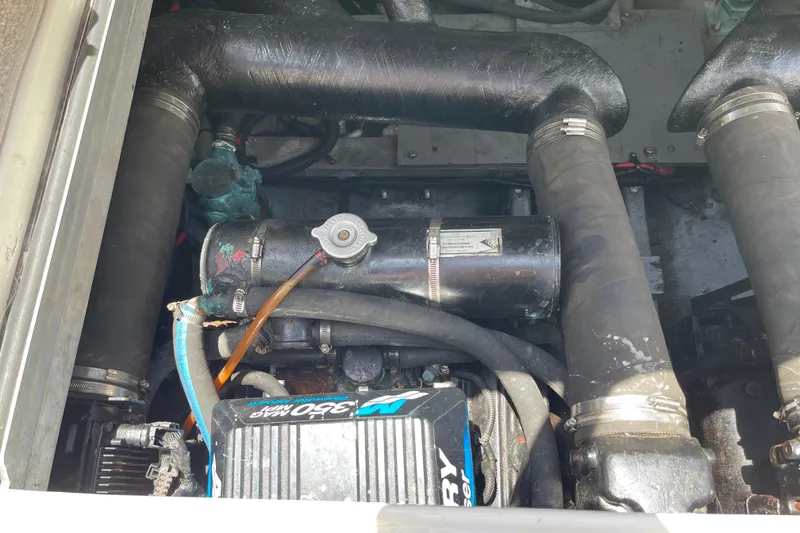 Slide: The Image of Engine compartment of a 2000 Sea Ray Sundancer 310 boat, featuring Mercury components. - 31