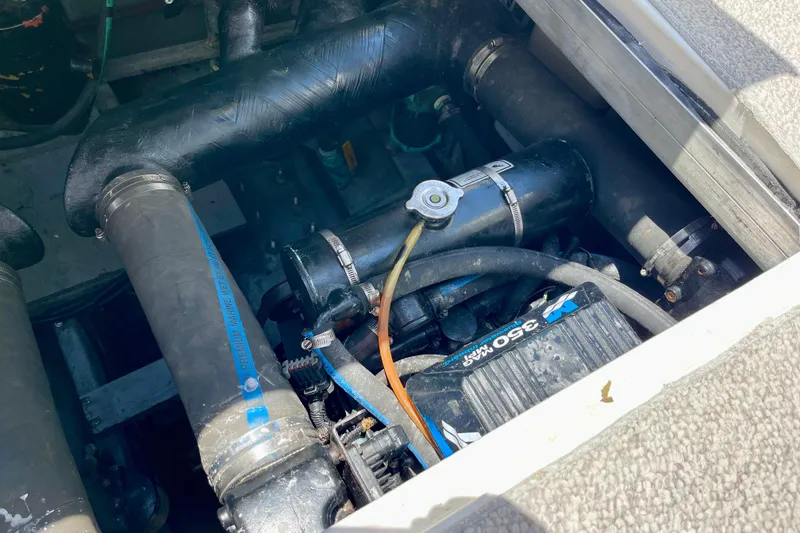 Slide: The Image of Engine compartment of a 2000 Sea Ray Sundancer 310 boat, showcasing mechanical components. - 32