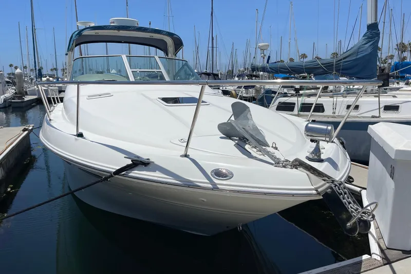 Slide: The Image of 2000 Sea Ray Sundancer 310 docked at marina, featuring sleek design and anchor. - 4