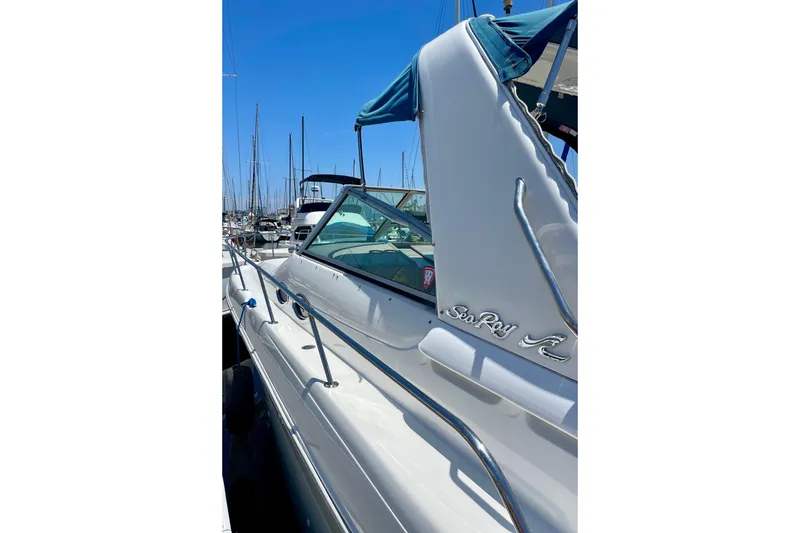 Slide: The Image of 2000 Sea Ray Sundancer 310 yacht docked at marina under clear blue sky. - 5
