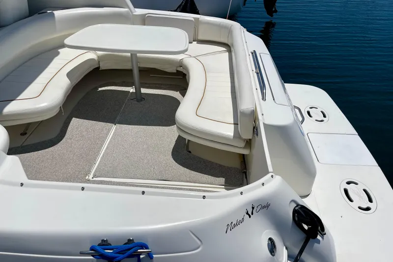 Slide: The Image of 2000 Sea Ray Sundancer 310 boat with white seating and table on calm water. - 9