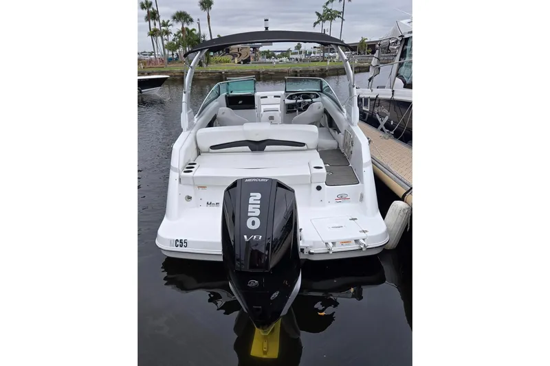 Slide: The Image of 2023 Four Winns HD5 OB boat with Mercury 250 V8 engine docked at marina. - 2