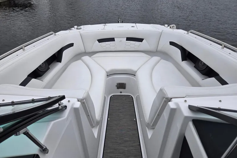 Slide: The Image of 2023 Four Winns HD5 OB boat interior with white cushioned seating and sleek design. - 3
