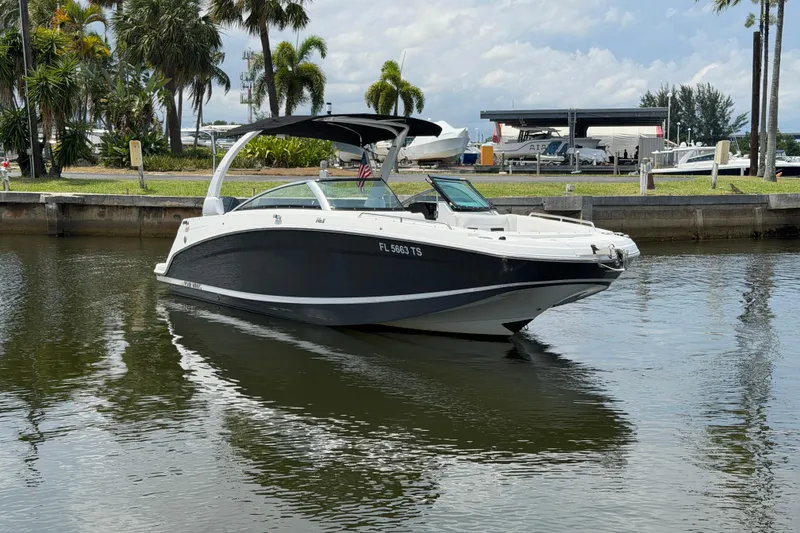 Slide: The Image of 2023 Four Winns HD5 OB boat on calm water, surrounded by tropical scenery. - 10