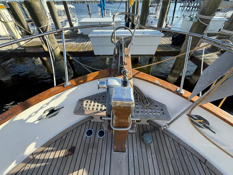 Slide: The Image of The image shows the bow of a 1981 Marine Trader Double Cabin, featuring an anchor and wooden details. - 14