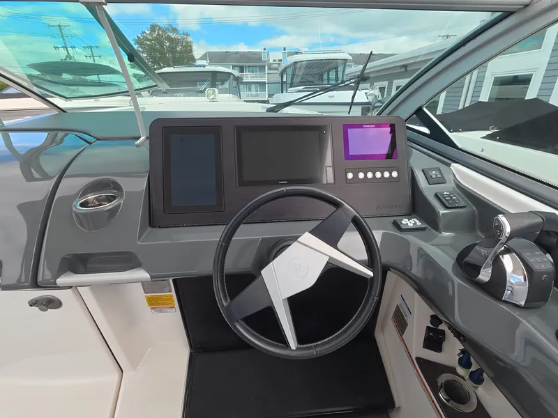 Slide: The Image of The cockpit of the 2021 Aviara AV32 OB features a modern steering wheel with multiple screens and controls. - 16