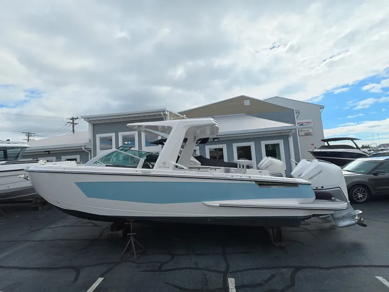Slide: The Image of A 2021 Aviara AV32 OB boat is parked on a lot in front of a building. - 1