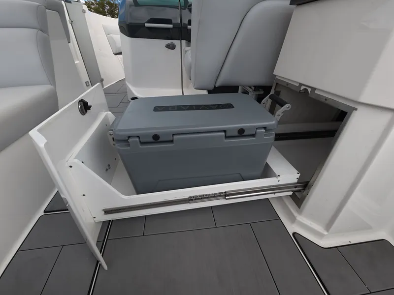 Slide: The Image of A gray cooler is installed in a pull-out compartment on an Aviara AV32 OB boat. - 12