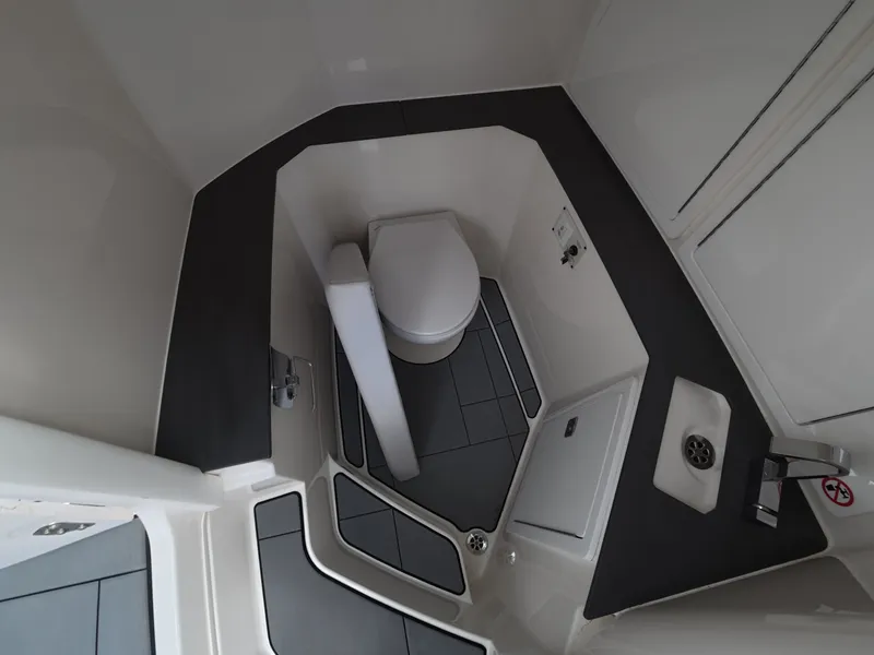 Slide: The Image of The image shows a modern boat bathroom with a toilet and a sink. - 20