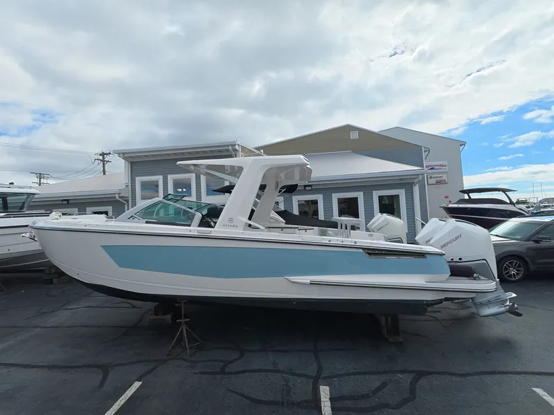 Slide: The Image of A 2021 Aviara AV32 OB boat is parked on a lot. It features a modern design. - 0