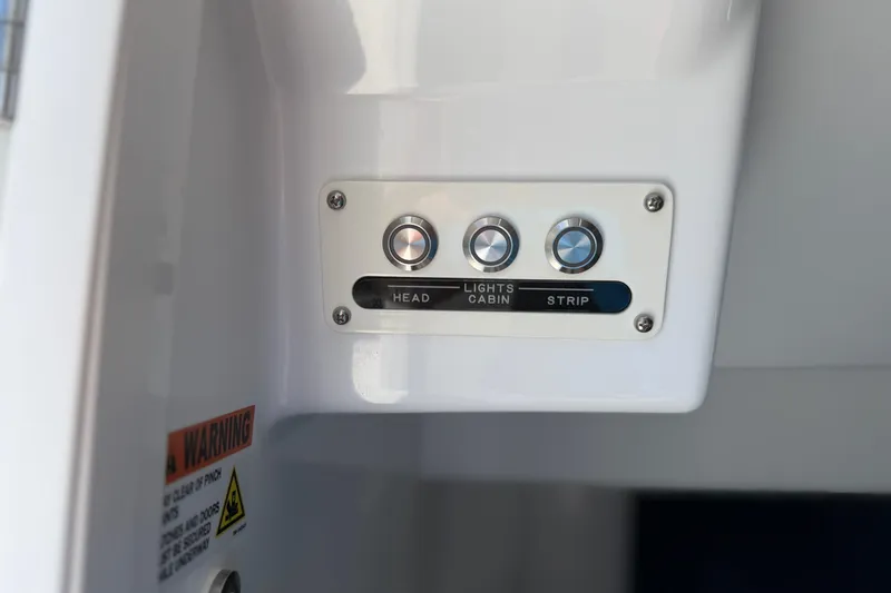 Slide: The Image of Control panel on 2026 Everglades 395 Center Console boat with labeled buttons. - 100