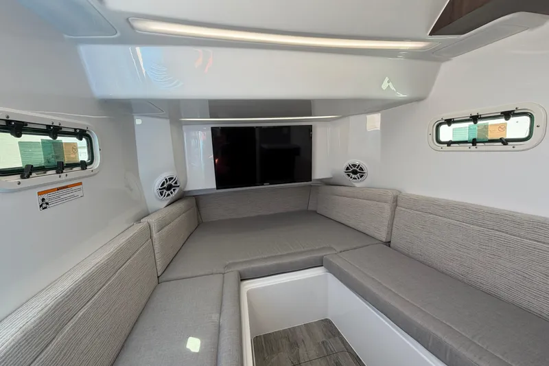 Slide: The Image of Interior of 2026 Everglades 395 Center Console boat with gray seating and windows. - 101