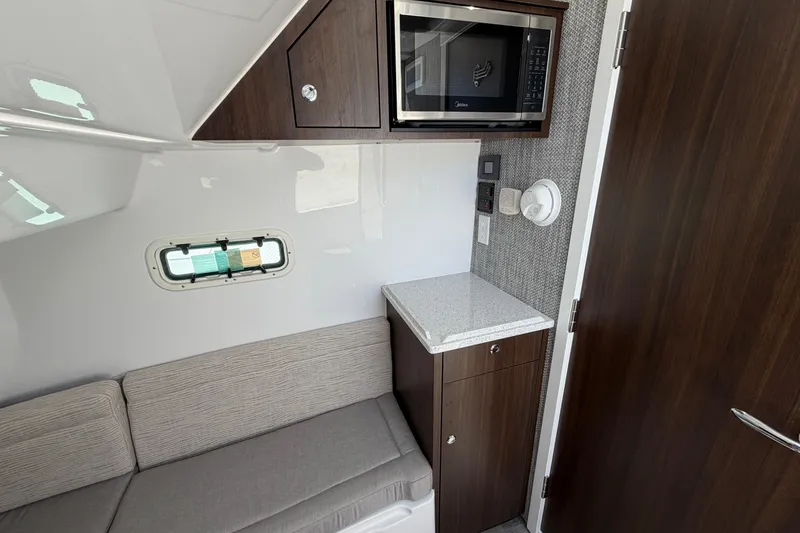 Slide: The Image of Interior of 2026 Everglades 395 Center Console with microwave and seating area. - 103