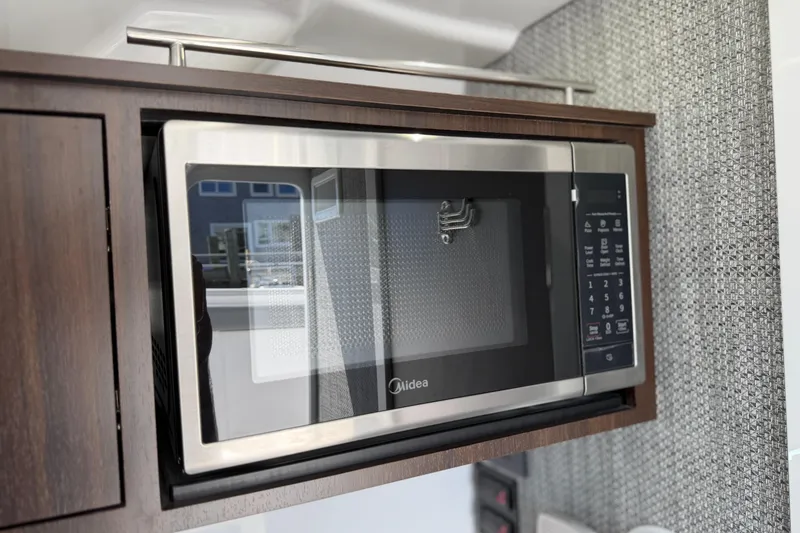Slide: The Image of Modern microwave in 2026 Everglades 395 Center Console boat interior. - 104