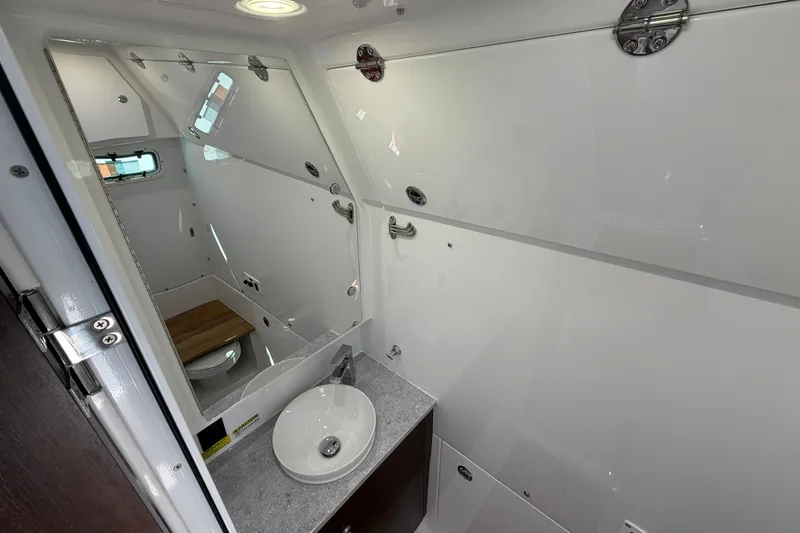 Slide: The Image of Interior of 2026 Everglades 395 Center Console boat bathroom with sink and toilet. - 107