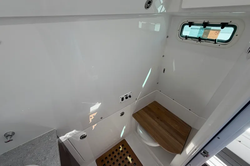 Slide: The Image of Interior of 2026 Everglades 395 Center Console boat, featuring a compact, modern bathroom. - 108