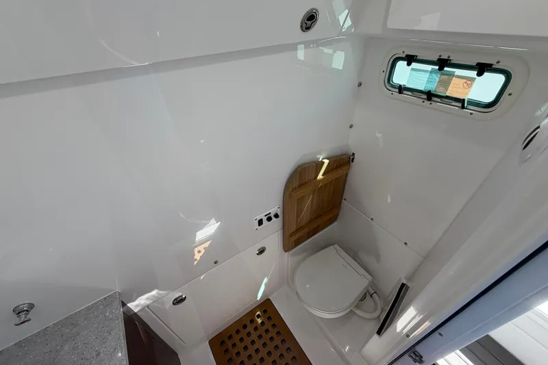 Slide: The Image of Interior of 2026 Everglades 395 Center Console boat bathroom with modern fixtures. - 109