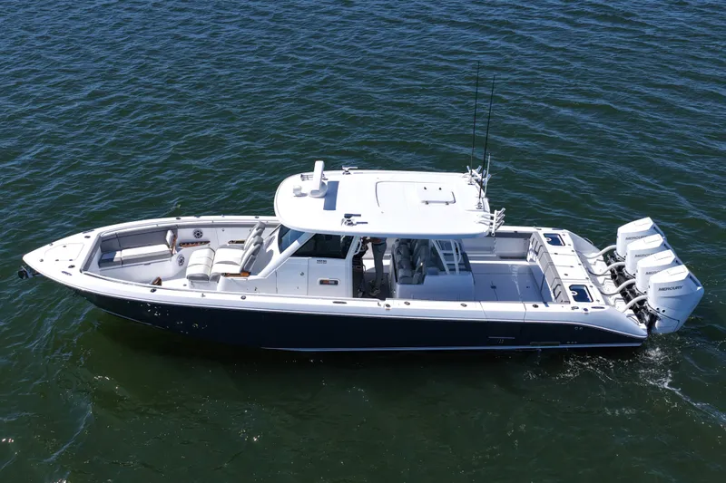 Slide: The Image of 2026 Everglades 395 Center Console boat on open water, featuring triple Mercury engines. - 14
