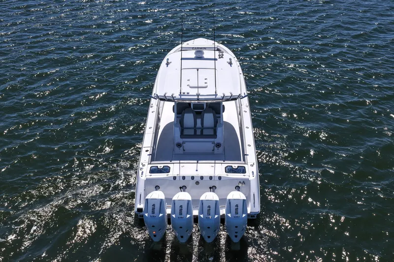 Slide: The Image of 2026 Everglades 395 Center Console boat with four engines on open water. - 15