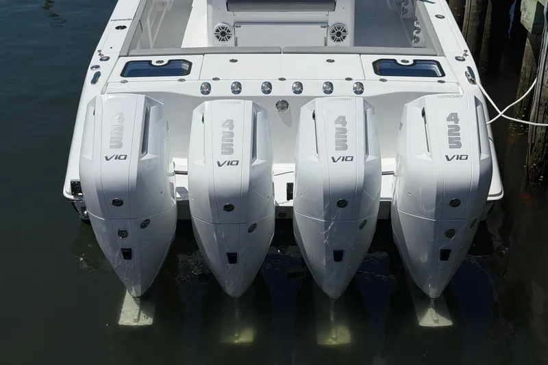 Slide: The Image of Four powerful outboard engines on a 2026 Everglades 395 Center Console boat. - 18