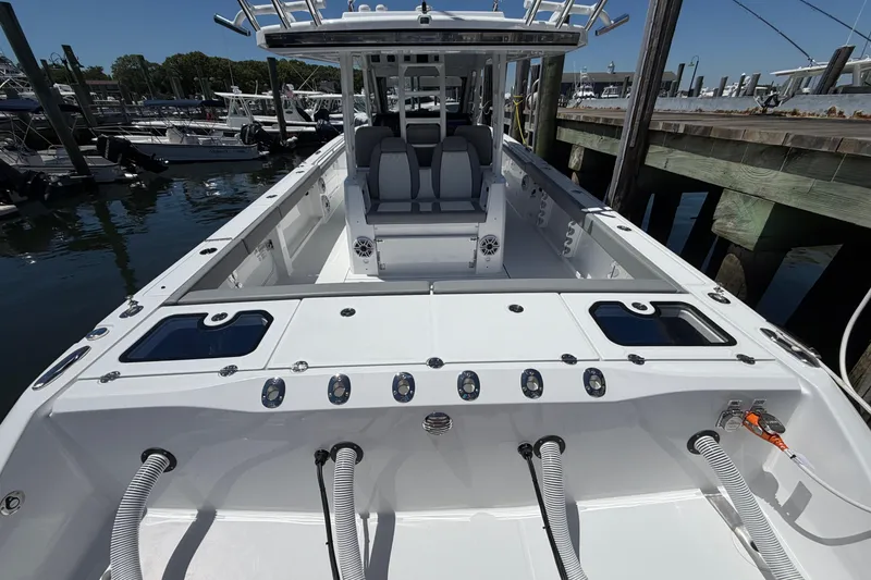 Slide: The Image of 2026 Everglades 395 Center Console boat docked, showcasing spacious deck and seating. - 20