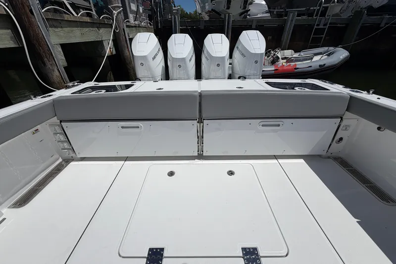 Slide: The Image of 2026 Everglades 395 Center Console boat with powerful Mercury engines docked at marina. - 24