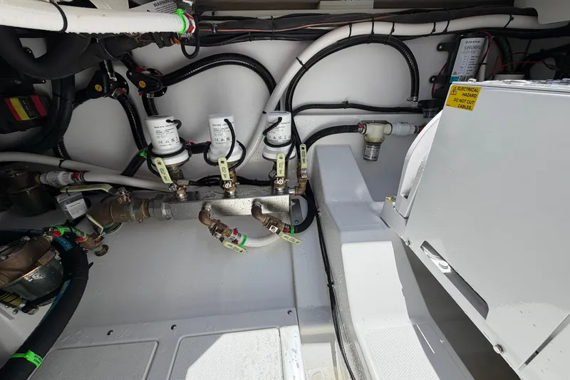 Slide: The Image of Engine compartment of 2026 Everglades 395 Center Console with visible wiring and components. - 28