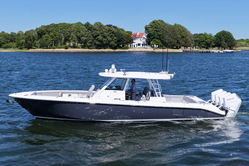 Slide: The Image of 2026 Everglades 395 Center Console boat cruising on a scenic lake. - 3