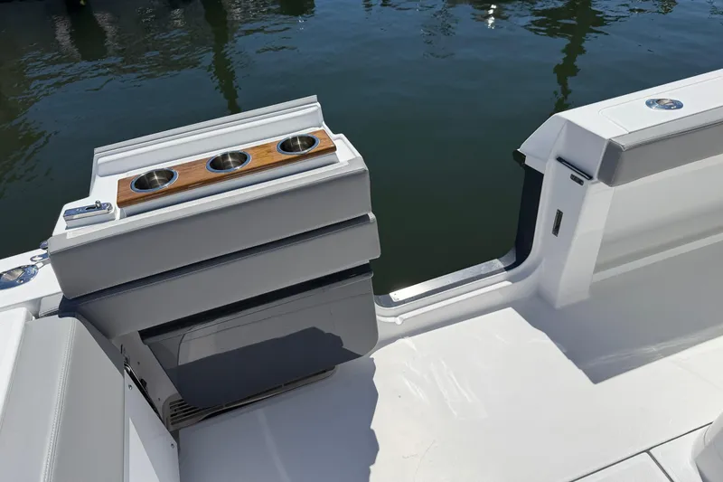 Slide: The Image of 2026 Everglades 395 Center Console boat interior with cup holders and sleek design. - 33
