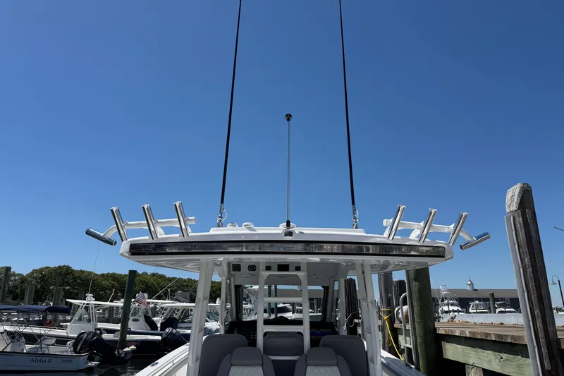 Slide: The Image of 2026 Everglades 395 Center Console boat docked under clear blue sky. - 34
